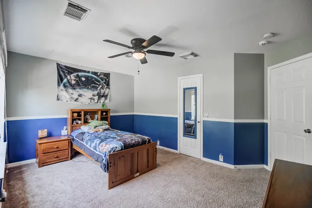 a bedroom with a bed and a chandelier