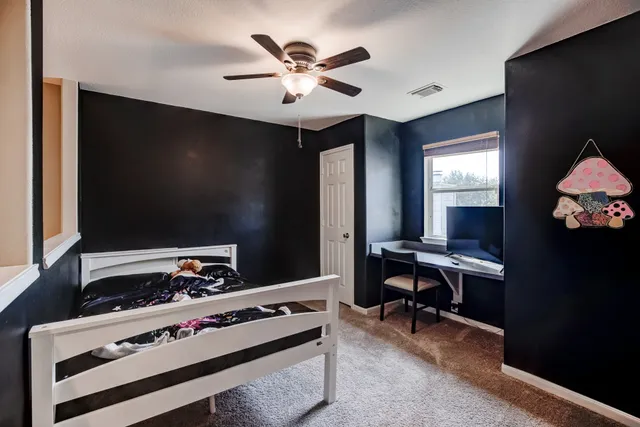 a work room with furniture and a flat screen tv