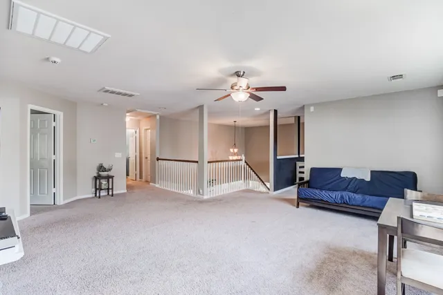 a living room with furniture and a chandelier