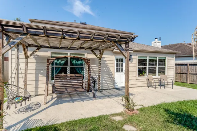 a front view of a house with outdoor seating and a garden
