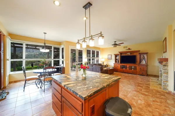 a kitchen with counter top space and windows