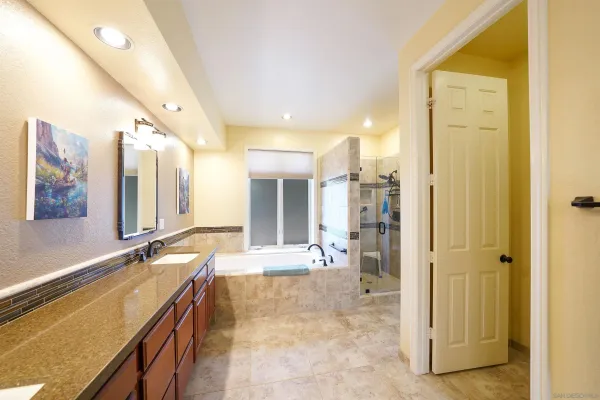 a large bathroom with a tub and shower