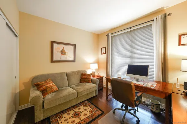 a view of a livingroom with workspace and a couch