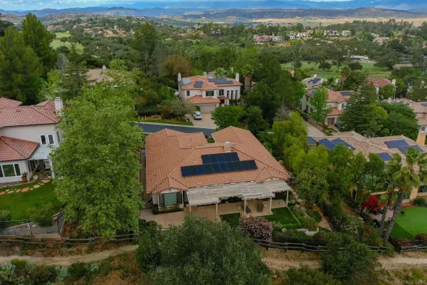 an aerial view of a house with a yard