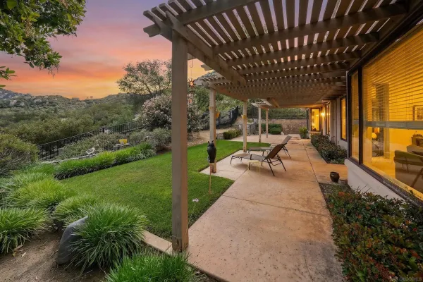 a view of a porch with furniture and garden