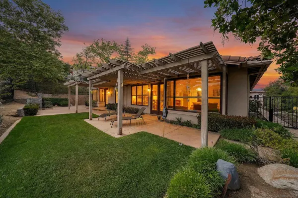 a view of a backyard with sitting area and slide