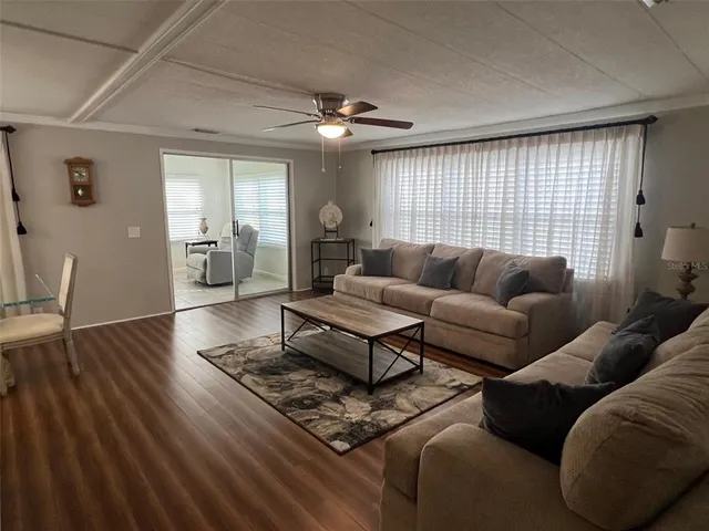 a living room with furniture and wooden floor