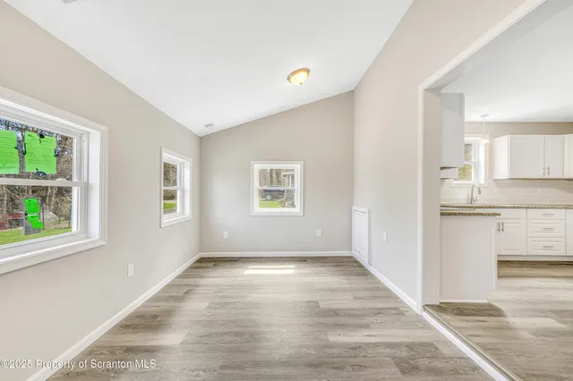 a view of a kitchen with wooden floor and a kitchen