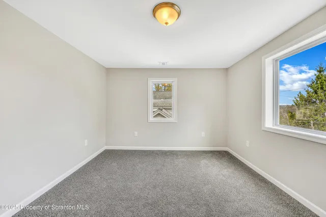 an empty room with windows and view