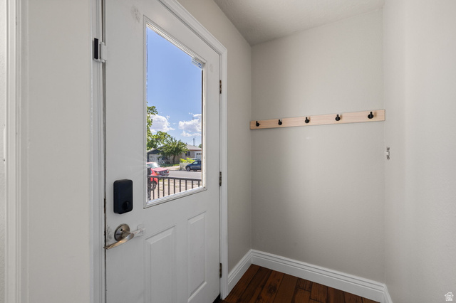 594 850 West Provo, UT 84601 - Photo 2 of 33 Entryway featuring a white door with a clear glass insert, contemporary door hardware, and a wall-mounted coat rack