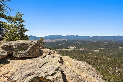a view of mountain view with lush green forest
