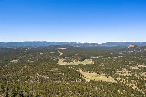 a view of a lush green hillside and a mountain view