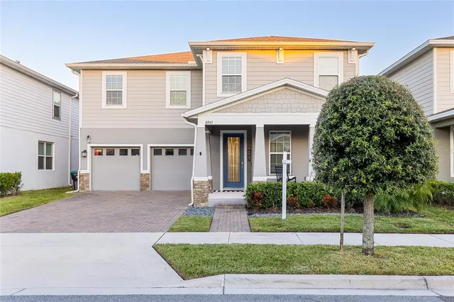 a view of a house with a yard and plants