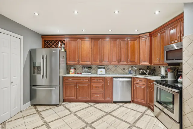 a kitchen with granite countertop stainless steel appliances and cabinets