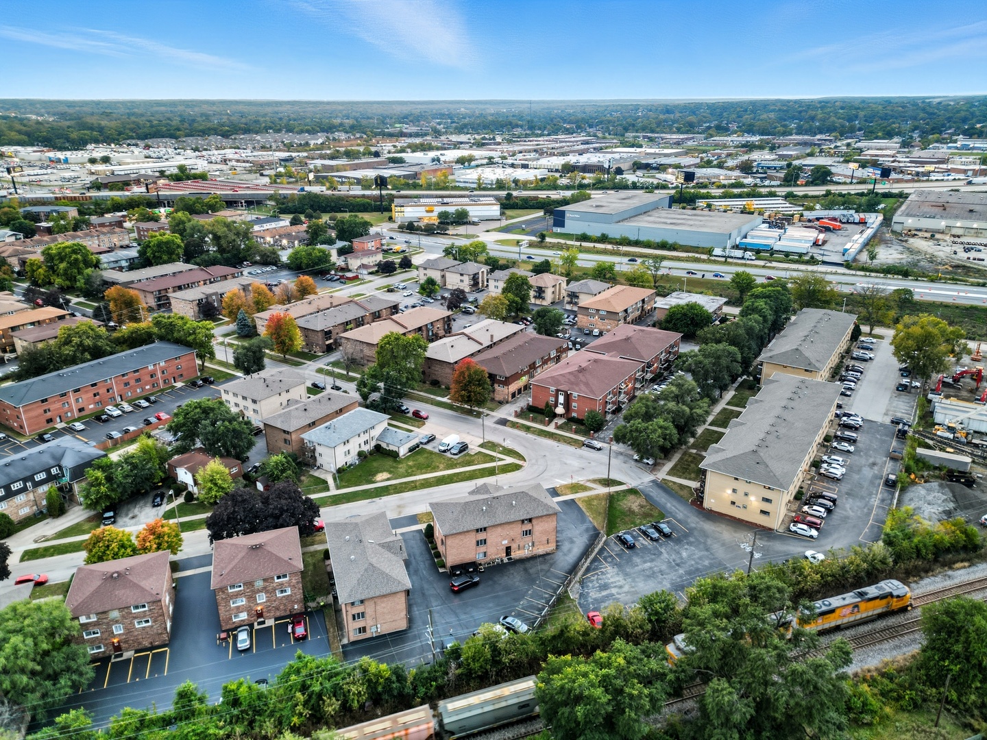 9708 Nottingham Avenue, Unit 9 Chicago Ridge, IL 60415 - Photo 25 of 26 an aerial view of a city with lots of residential buildings and ocean view in back