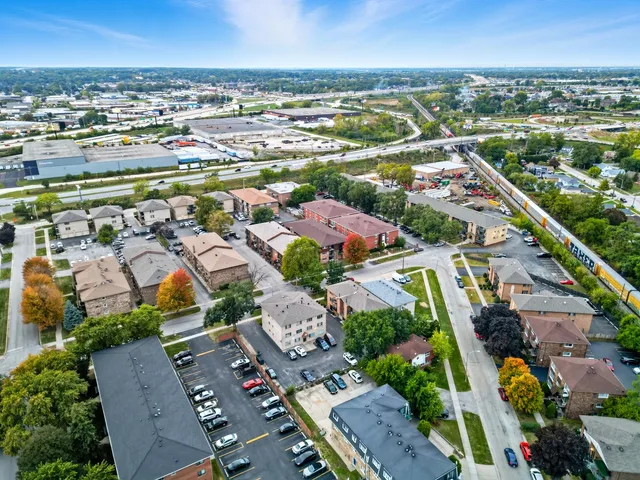 an aerial view of residential houses with outdoor space