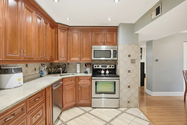 a kitchen with stainless steel appliances granite countertop a refrigerator sink and cabinets