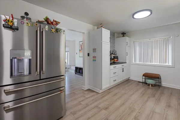 a kitchen with stainless steel appliances a refrigerator and a stove top oven