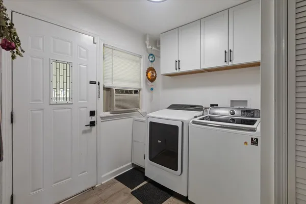 a view of storage and utility room with washer and dryer