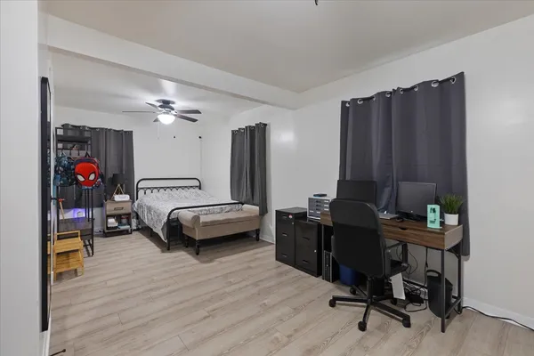 a bedroom with furniture and a wooden floor