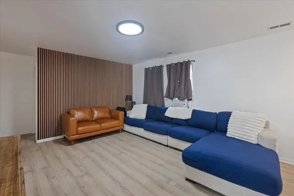 a living room with furniture and wooden floor