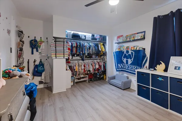 a view of a room with lots of stuff and hardwood floor