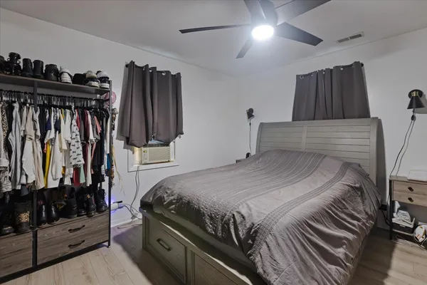 a bedroom with a bed and a mirror