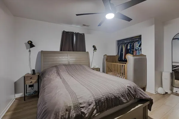 a bedroom with a bed and a mirror