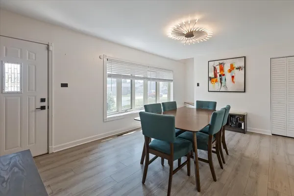 a view of a dining room with furniture window and wooden floor