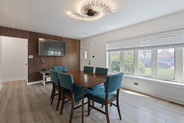 a view of a dining room with furniture and a large window