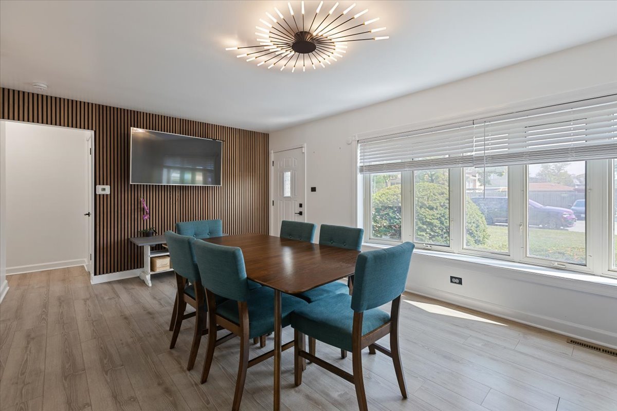7506 Ferdinand Avenue Bridgeview, IL 60455 - Photo 9 of 32 a view of a dining room with furniture and a large window