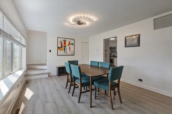a view of a dining room with furniture and wooden floor