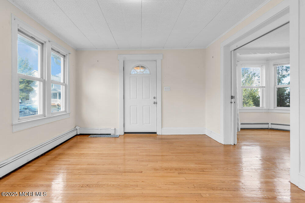 737 20th Avenue Lake Como, NJ 07719 - Photo 4 of 29 a view of an empty room with wooden floor and a window
