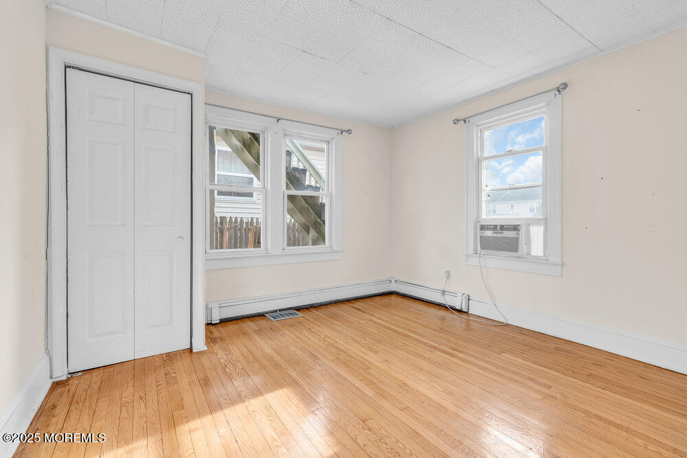 737 20th Avenue Lake Como, NJ 07719 - Photo 8 of 29 a view of an empty room with wooden floor and a window