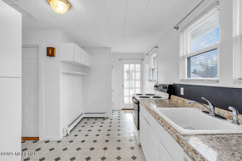 737 20th Avenue Lake Como, NJ 07719 - Photo 10 of 29 a kitchen with a sink a stove and a window