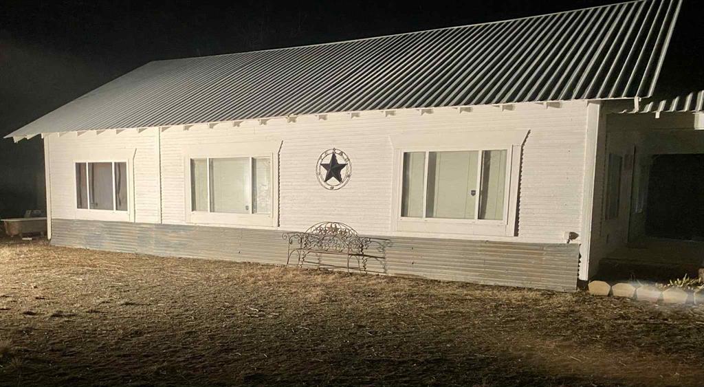 8108 Fm2111 Winters, TX 79567 - Photo 12 of 29 Property exterior at twilight featuring a metal roof and brick siding