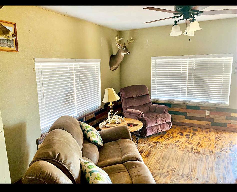 8108 Fm2111 Winters, TX 79567 - Photo 10 of 29 Living area featuring wood finished floors and ceiling fan