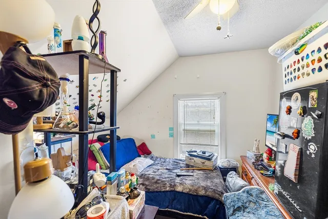 a bedroom with bed and a window