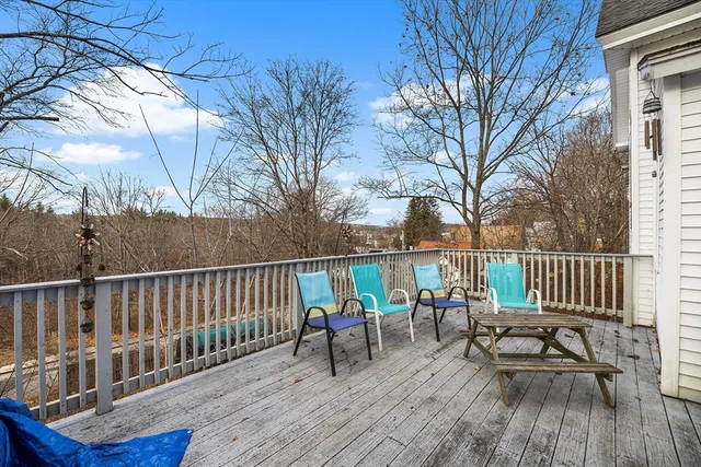 a view of a deck with chairs and wooden floor