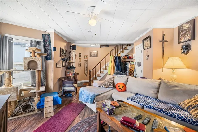 a living room with furniture and wooden floor