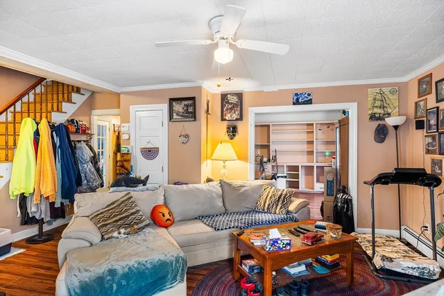 a living room with furniture a chandelier and a window