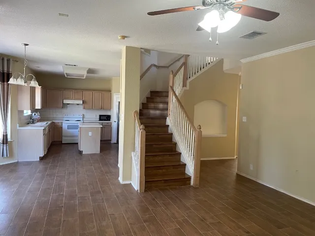 a view of a kitchen with furniture and a ceiling fan