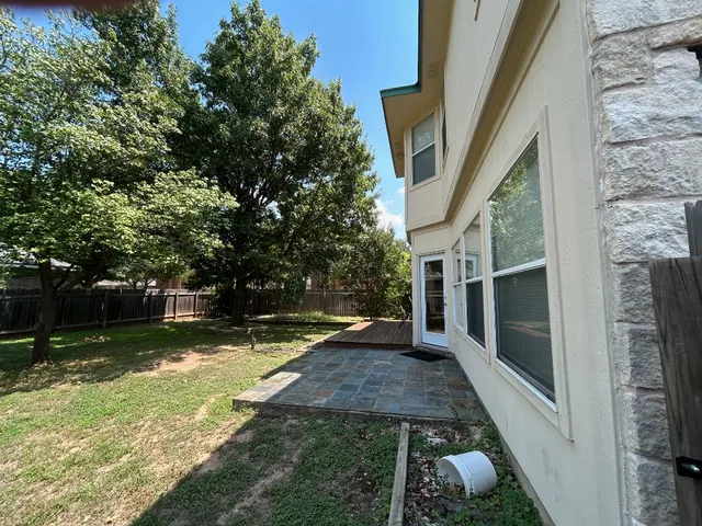 a view of a porch with chairs and a yard