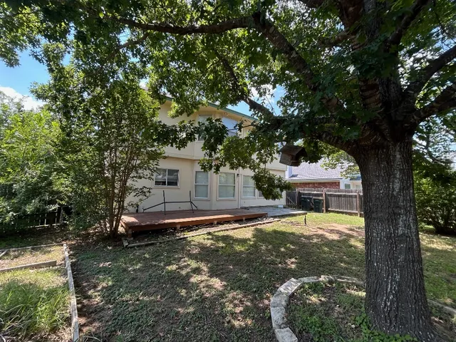 a house view with a sitting space tree s