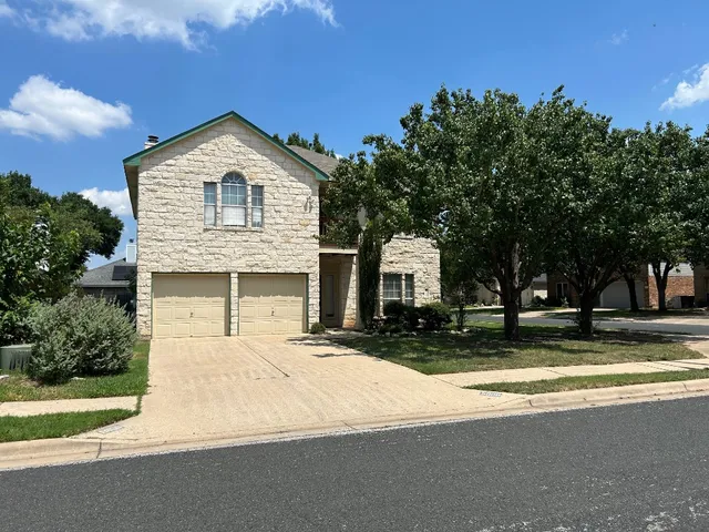 a large house with a large tree in front of it