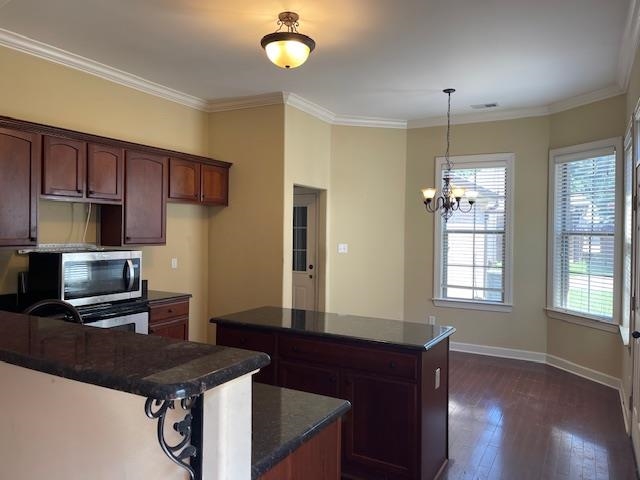 6916 Lagrange Pines Road Cordova, TN 38018 - Photo 3 of 13 Kitchen with stainless steel microwave, dark wood-style flooring, a center island, a chandelier, and crown molding