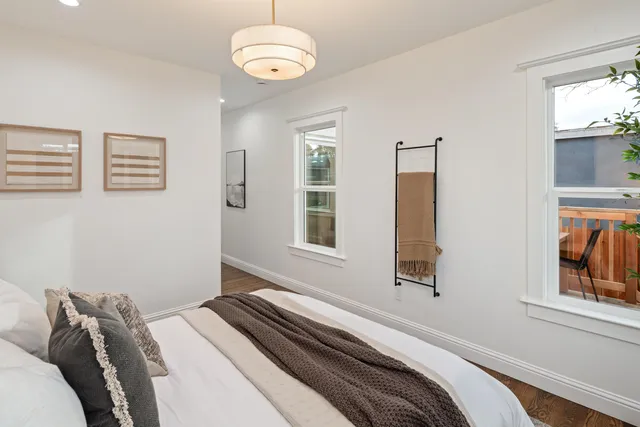 a bedroom with a bed lamps and window