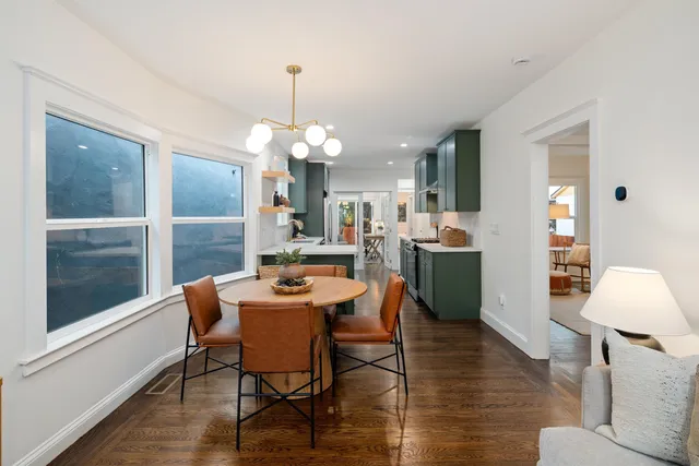 a dining room with a wooden table and chairs