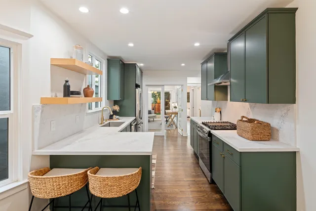 a kitchen with stainless steel appliances a refrigerator and a sink