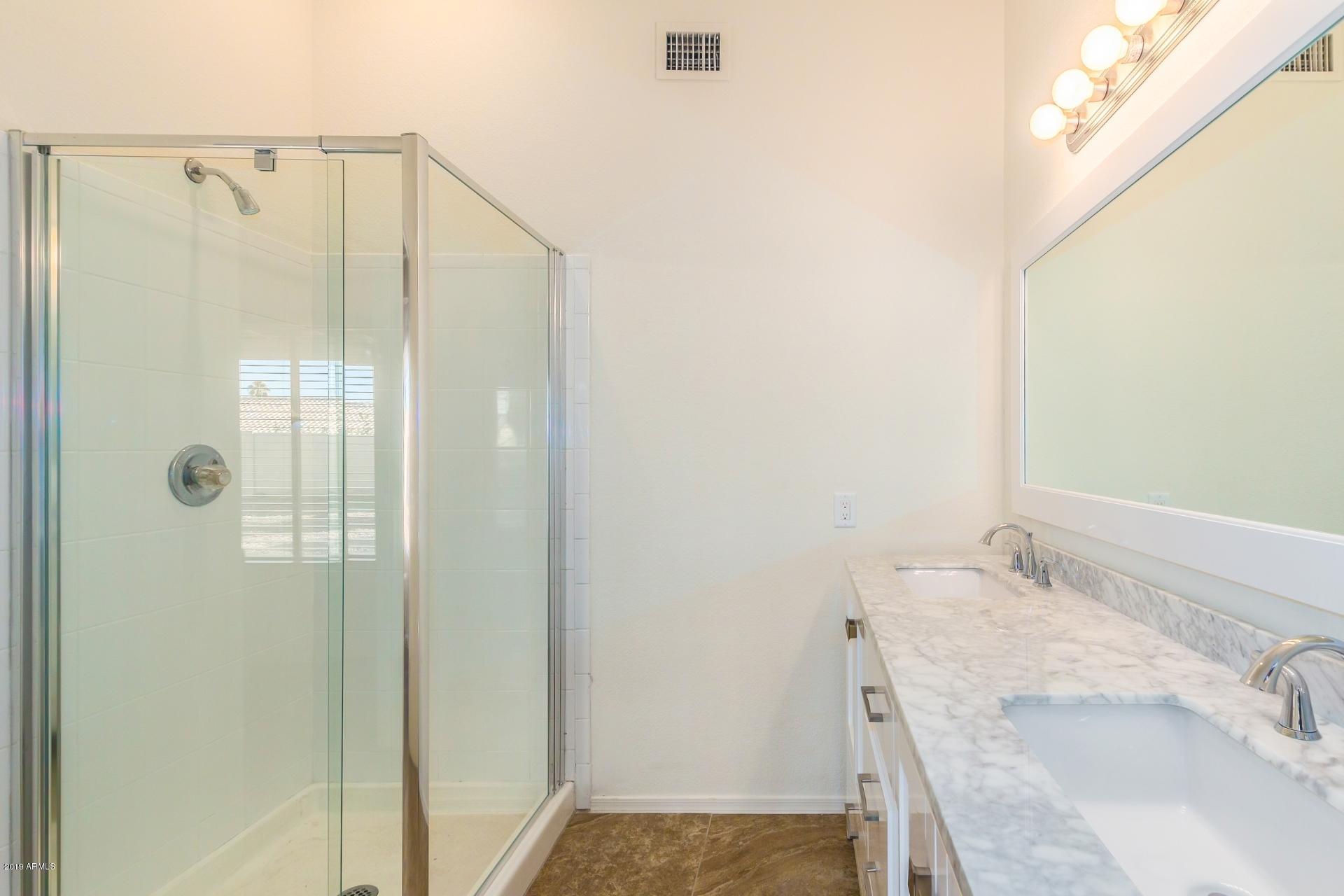 213 West Marco Polo Road Phoenix, AZ 85027 - Photo 11 of 21 a bathroom with a granite countertop sink and shower